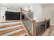Bright stairway with decorative iron and wood staircase, leading to an upstairs living area at 118 Village Green Ave, Woodstock, GA 30189
