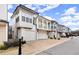 Street view of attractive townhomes featuring garages and architectural details at 118 Village Green Ave, Woodstock, GA 30189