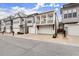 Street view of elegant townhomes showcasing garages, architectural design, and landscaping at 118 Village Green Ave, Woodstock, GA 30189