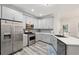 Kitchen featuring stainless steel appliances, gray cabinets and mosaic backsplash at 1625 Watercrest Dr, Cumming, GA 30041