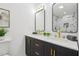 Bathroom features a double vanity with gold hardware, modern mirrors, and stylish fixtures at 169 Wadley Nw St, Atlanta, GA 30314