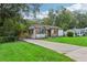 Beautifully landscaped front yard with a charming home, a long driveway, and a covered carport at 169 Wadley Nw St, Atlanta, GA 30314