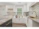 Bright kitchen features white cabinets, granite countertops, and stylish backsplash at 169 Wadley Nw St, Atlanta, GA 30314