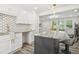 Bright kitchen features white cabinets, granite countertops, and a gray island at 169 Wadley Nw St, Atlanta, GA 30314