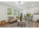 Inviting living room with large windows, stylish decor, and laminate floors at 169 Wadley Nw St, Atlanta, GA 30314