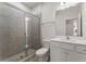 Bathroom with glass shower, tile, white vanity with sink and door to separate room at 3218 Hidden Valley Cir, Lawrenceville, GA 30044