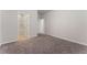 A carpeted bedroom featuring a private ensuite bathroom with tiled floors at 3218 Hidden Valley Cir, Lawrenceville, GA 30044