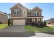Charming two-story home with brick and stone accents, a two-car garage, and a well-manicured front lawn at 3218 Hidden Valley Cir, Lawrenceville, GA 30044