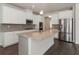 Modern kitchen features a large island with granite countertops, stainless steel appliances and white cabinets at 3218 Hidden Valley Cir, Lawrenceville, GA 30044