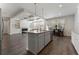 Open kitchen features a large island with granite countertops and stainless steel appliances, flowing into the living room at 3218 Hidden Valley Cir, Lawrenceville, GA 30044