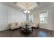 Bright living room with coffered ceiling, hardwood floors, and large windows providing natural light at 3218 Hidden Valley Cir, Lawrenceville, GA 30044