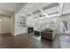 Cozy living room with hardwood floors, coffered ceiling, built-in shelving, and a fireplace at 3218 Hidden Valley Cir, Lawrenceville, GA 30044