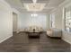 Bright living room with coffered ceiling, hardwood floors, and large windows providing natural light at 3218 Hidden Valley Cir, Lawrenceville, GA 30044
