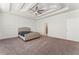 Spacious primary bedroom featuring decorative ceilings, plush carpet and a walk-in closet at 3218 Hidden Valley Cir, Lawrenceville, GA 30044