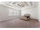 Main bedroom with tray ceilings, decorative wall trim, neutral walls, and plush carpet at 3218 Hidden Valley Cir, Lawrenceville, GA 30044