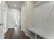 Bright mudroom with hardwood floors, white bench with storage and coat hooks at 3218 Hidden Valley Cir, Lawrenceville, GA 30044