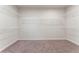 Spacious walk-in closet with carpet and white wire shelving for optimal storage at 3218 Hidden Valley Cir, Lawrenceville, GA 30044