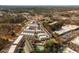 Aerial view of modern townhomes in a walkable community, featuring a community pool and easy access to commercial centers at 472 Burton Dr, Alpharetta, GA 30009