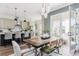 Bright dining area featuring wood table, pendant lighting, and open access to a balcony at 472 Burton Dr, Alpharetta, GA 30009