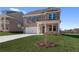 Inviting two story brick home featuring a two car garage, manicured lawn, and concrete driveway at 116 Dalston Cv, Stockbridge, GA 30281