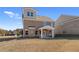 New two-story brick home with a covered porch, expansive backyard, and blue sky at 116 Dalston Cv, Stockbridge, GA 30281