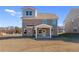 New two-story brick home with a covered porch, expansive backyard, and blue sky at 116 Dalston Cv, Stockbridge, GA 30281