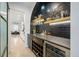 Chic bar area with black tile, custom shelving, and a wine refrigerator at 120 Woodford Ln, Canton, GA 30115