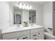 Modern bathroom featuring a double sink vanity, a large mirror, and neutral color palette at 120 Woodford Ln, Canton, GA 30115