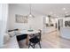 Bright dining area with white marble table, chairs, and view into the modern kitchen at 120 Woodford Ln, Canton, GA 30115