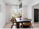 Modern dining room with a dark wood table, stylish chairs, and elegant white curtains at 120 Woodford Ln, Canton, GA 30115