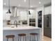 Bright kitchen featuring white cabinetry, a center island with bar stools, and modern fixtures at 120 Woodford Ln, Canton, GA 30115