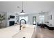 A kitchen featuring a sink with an island with a view of the fireplace and dining room at 120 Woodford Ln, Canton, GA 30115