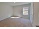 Cozy bedroom with neutral walls, plush carpeting, a window, and a closet at 15 Heyman Dr, Covington, GA 30016