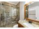 Bathroom boasts a tiled shower with a glass door and granite countertop at 2190 Rugby Ave, Atlanta, GA 30337