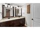 Bathroom featuring a double sink vanity with granite countertops and dark wood cabinets at 2190 Rugby Ave, Atlanta, GA 30337