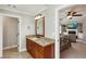 Bathroom vanity with granite countertop with door leading into bedroom with fireplace and TV at 2190 Rugby Ave, Atlanta, GA 30337