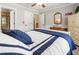 Bedroom boasts wainscoting, blue accents and an ensuite bathroom with tub and shower at 2190 Rugby Ave, Atlanta, GA 30337