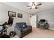 Bedroom with a ceiling fan, a sofa, a desk with a chair, and a TV on the wall at 2190 Rugby Ave, Atlanta, GA 30337