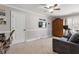 Bedroom with a ceiling fan, a sofa, a desk with a chair, and a TV on the wall at 2190 Rugby Ave, Atlanta, GA 30337