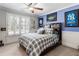 Bedroom featuring window with shutters, ceiling fan and sports-themed decor at 2190 Rugby Ave, Atlanta, GA 30337