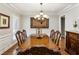 Formal dining room with hardwood floors, elegant chandelier, and classic wood furniture at 2190 Rugby Ave, Atlanta, GA 30337