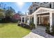 Charming gray two-story house featuring a cozy front porch with stone accents and manicured landscaping at 2190 Rugby Ave, Atlanta, GA 30337