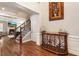 Spacious foyer with hardwood floors, elegant staircase, and decorative console table at 2190 Rugby Ave, Atlanta, GA 30337