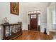 Grand foyer with hardwood floors, decorative console table, and beautiful front door with sidelights at 2190 Rugby Ave, Atlanta, GA 30337