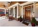 Inviting front porch with seating, stone accents, and a beautiful wood door with decorative glass at 2190 Rugby Ave, Atlanta, GA 30337