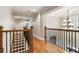 Upstairs hallway with hardwood floors and wrought iron railing at 2190 Rugby Ave, Atlanta, GA 30337