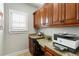 Home office area with built-in cabinets, granite countertop, and natural light from a window at 2190 Rugby Ave, Atlanta, GA 30337