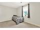 Cozy bedroom featuring neutral walls and a window for natural light at 3653 Memorial Nw Pkwy, Kennesaw, GA 30152