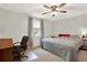 Bedroom featuring a queen bed, ceiling fan, curtains, and carpet flooring at 3653 Memorial Nw Pkwy, Kennesaw, GA 30152