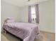 Cozy bedroom featuring a twin bed, a window with plants, and neutral wall color at 3653 Memorial Nw Pkwy, Kennesaw, GA 30152